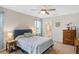 Serene main bedroom with ceiling fan, ensuite bathroom, and a relaxing ambiance at 25292 E Lenox Cir, Punta Gorda, FL 33950