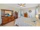 Cozy bedroom featuring a comfortable bed, dresser, and ceiling fan at 25292 E Lenox Cir, Punta Gorda, FL 33950