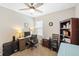 Bright home office with computer, desk, bookshelf, ceiling fan, and natural light at 25292 E Lenox Cir, Punta Gorda, FL 33950