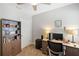 Carpeted office with a desk, computer, bookshelf, and neutral walls at 25292 E Lenox Cir, Punta Gorda, FL 33950