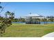 Outdoor picnic area with shaded seating by the lake, perfect for Gathering gatherings and community events at 25292 E Lenox Cir, Punta Gorda, FL 33950