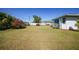 Lush green backyard with well maintained lawn, surrounded by a variety of plants and shrubbery at 3753 Aba Ln, North Port, FL 34287