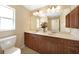 Bathroom featuring double sinks, and wood cabinetry at 3753 Aba Ln, North Port, FL 34287