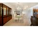 Elegant dining space with chandelier lighting that adjoins the living room and offers a seamless transition to the kitchen at 3753 Aba Ln, North Port, FL 34287
