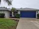 Charming home with a well-kept lawn, landscaped flower beds, and a two-car garage at 3753 Aba Ln, North Port, FL 34287