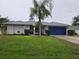 Well-maintained single-Gathering home featuring a lush green lawn and mature palm tree at 3753 Aba Ln, North Port, FL 34287