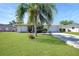 Lovely single-story home featuring a well-manicured lawn, mature landscaping, and a convenient two-car garage with long driveway at 3753 Aba Ln, North Port, FL 34287