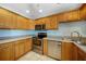 Inviting kitchen featuring sleek stainless steel appliances, honey maple cabinets, and ample countertop space for meal prep at 3753 Aba Ln, North Port, FL 34287