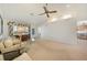Bright living room featuring neutral carpeting, vaulted ceilings, and large windows that stream in natural light at 3753 Aba Ln, North Port, FL 34287
