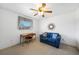 Home office with a wooden desk, a blue loveseat, and a ceiling fan at 3753 Aba Ln, North Port, FL 34287
