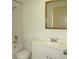 A clean bathroom features a white vanity, mirror, toilet, and a tiled shower and tub combination at 409 Ricold Ter, Port Charlotte, FL 33954