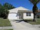 Charming one-story home with a well-manicured lawn and a two-car garage at 409 Ricold Ter, Port Charlotte, FL 33954