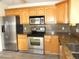 Modern kitchen with stainless steel appliances, granite countertops, and ample cabinet space at 409 Ricold Ter, Port Charlotte, FL 33954