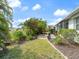 Landscaped backyard with a brick-paver patio and lush green lawn at 478 Winwood Ct, Port Charlotte, FL 33954