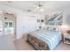 Bright bedroom with a beach-themed bed and ceiling fan shows access to another room at 478 Winwood Ct, Port Charlotte, FL 33954