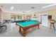 A billiards room featuring two well-maintained pool tables and comfortable seating for residents to enjoy at 478 Winwood Ct, Port Charlotte, FL 33954
