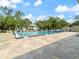 Large community pool surrounded by palm trees and lounge chairs, perfect for relaxation and recreation at 478 Winwood Ct, Port Charlotte, FL 33954