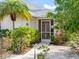 Inviting front entrance with lush landscaping and a decorative security door at 478 Winwood Ct, Port Charlotte, FL 33954