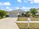 Charming single-story home with a well-maintained lawn and two-car garage at 478 Winwood Ct, Port Charlotte, FL 33954