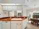 Bright kitchen features a white sink and cabinets, wood countertop, and Bosch dishwasher at 478 Winwood Ct, Port Charlotte, FL 33954