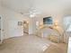 Bright main bedroom with tile floors includes a vanity area and an ensuite bathroom at 478 Winwood Ct, Port Charlotte, FL 33954