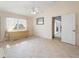 Well-lit main bedroom features tile flooring, a ceiling fan, and access to another room at 478 Winwood Ct, Port Charlotte, FL 33954