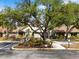 The Oak Hollow Recreation Center building boasts a well-kept exterior with beautiful landscaping and mature trees at 478 Winwood Ct, Port Charlotte, FL 33954