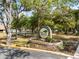 The Oak Hollow Recreation Center sign is surrounded by mature trees and landscaping, welcoming visitors to the community at 478 Winwood Ct, Port Charlotte, FL 33954