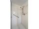Bathroom shower with white tile and a grab bar for accessibility at 478 Winwood Ct, Port Charlotte, FL 33954