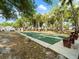 Community shuffleboard court featuring benches and surrounding trees for a relaxing outdoor activity at 478 Winwood Ct, Port Charlotte, FL 33954