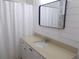 Bathroom featuring a modern vanity, mirror, and shower with white accents at 5421 Holiday Park Blvd, North Port, FL 34287