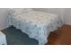 Comfortable bedroom with tropical pattern bedding, bright lighting, and wood floors at 5421 Holiday Park Blvd, North Port, FL 34287