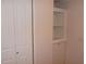 Bright closet space featuring bifold doors and built-in shelving for organized storage at 5421 Holiday Park Blvd, North Port, FL 34287