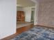 View of the dining room adjacent to the living area with hardwood floors at 5421 Holiday Park Blvd, North Port, FL 34287