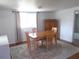 Cozy dining room featuring a wooden table set, a neutral rug, and abundant natural light, perfect for Gathering meals at 5421 Holiday Park Blvd, North Port, FL 34287