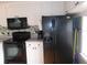 Well-equipped kitchen featuring ample counter space, black appliances, and functional layout at 5421 Holiday Park Blvd, North Port, FL 34287