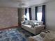 Inviting living room with a plush sofa, brick accent wall, and stylish blue rug, creating a cozy atmosphere at 5421 Holiday Park Blvd, North Port, FL 34287