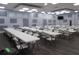 Community meeting room featuring rows of tables and chairs, ready for gatherings and events at 5421 Holiday Park Blvd, North Port, FL 34287
