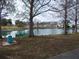 Scenic pond view framed by trees, with a fountain and lush greenery adding to the serene ambiance at 5421 Holiday Park Blvd, North Port, FL 34287