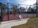 Community tennis court with a fence and a sign at 5421 Holiday Park Blvd, North Port, FL 34287