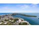 Breathtaking aerial view of waterfront condo community, lush mangroves, blue waters, and clear skies at 600 Sutton Pl # 101B, Longboat Key, FL 34228