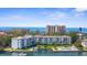 Gorgeous aerial view of beachfront condos with private boat docks and a refreshing community pool at 600 Sutton Pl # 101B, Longboat Key, FL 34228