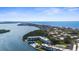 Breathtaking aerial view of waterfront condos with boat docks, a pool, and coastal scenery at 600 Sutton Pl # 101B, Longboat Key, FL 34228