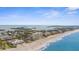 Expansive aerial view of the beachside condos with beautiful Gulf views and beach access at 600 Sutton Pl # 101B, Longboat Key, FL 34228
