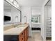 Bathroom with a neutral vanity and a view into the bright bedroom at 600 Sutton Pl # 101B, Longboat Key, FL 34228