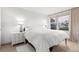 Well-lit bedroom features bright white walls and furnishings along with a comfortable bed at 600 Sutton Pl # 101B, Longboat Key, FL 34228