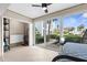 Bedroom with tile flooring, a ceiling fan, and sliding glass doors to the outdoors at 600 Sutton Pl # 101B, Longboat Key, FL 34228