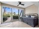 Bedroom featuring a ceiling fan, tile flooring, and sliding glass doors to the outdoors at 600 Sutton Pl # 101B, Longboat Key, FL 34228
