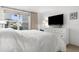 Bright bedroom featuring a dresser, large window with shades, and a comfortable bed at 600 Sutton Pl # 101B, Longboat Key, FL 34228
