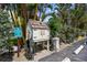Exterior shot of car wash station with reserved parking sign and wooded surrounding area at 600 Sutton Pl # 101B, Longboat Key, FL 34228